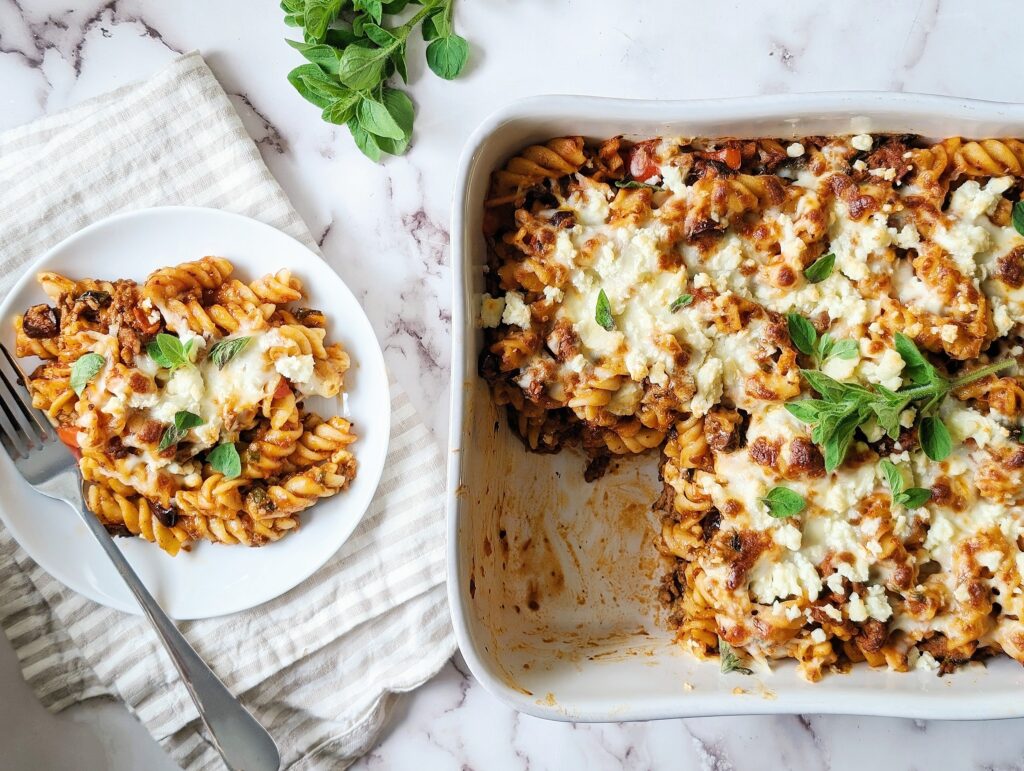 one pot Greek pasta bake top down view with portion on a plate close up