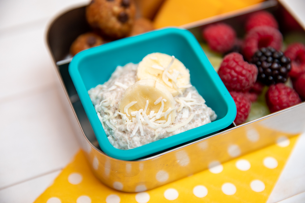 close up view of coconut banana chia pudding in a lunch box, which makes a perfect healthy snack for teens