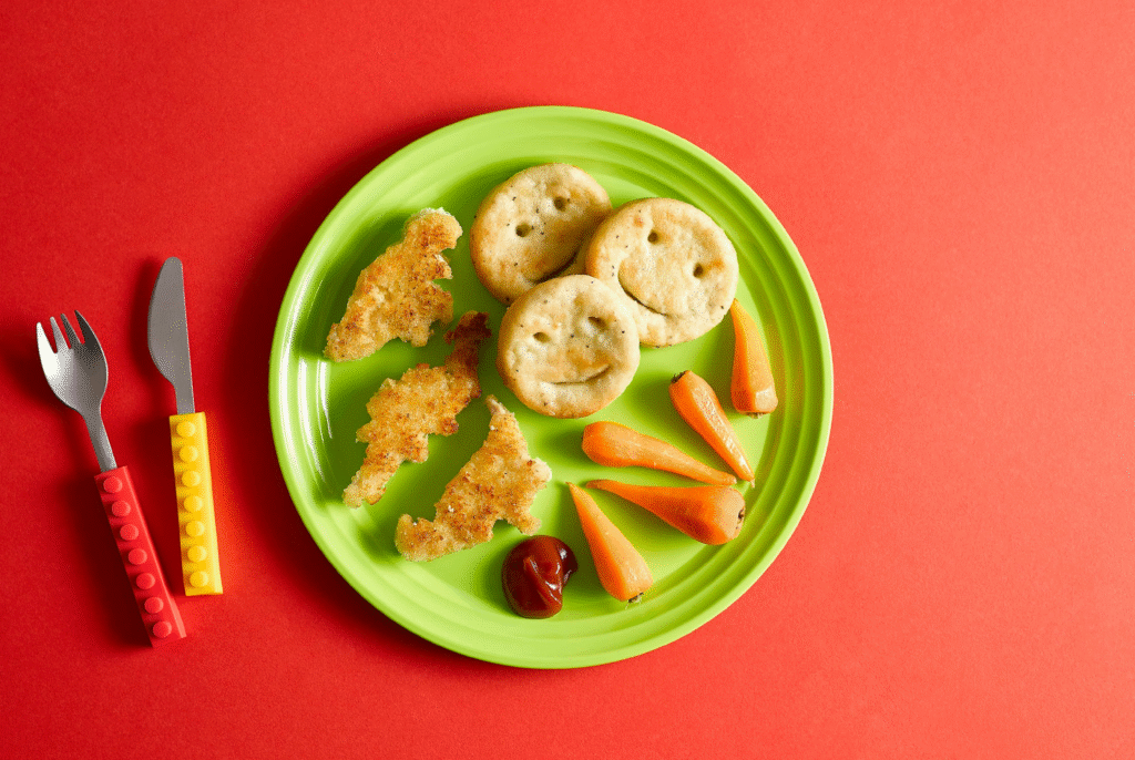 top down view of a plate full of ultra-processed foods for kids including chicken nuggets