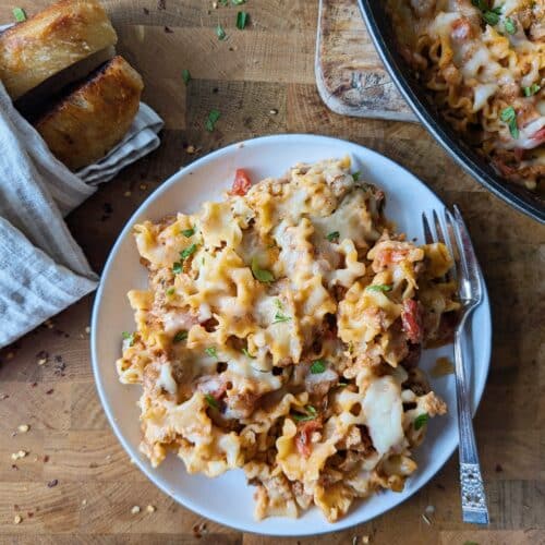 skillet lasagna in a bowl with bread on the side