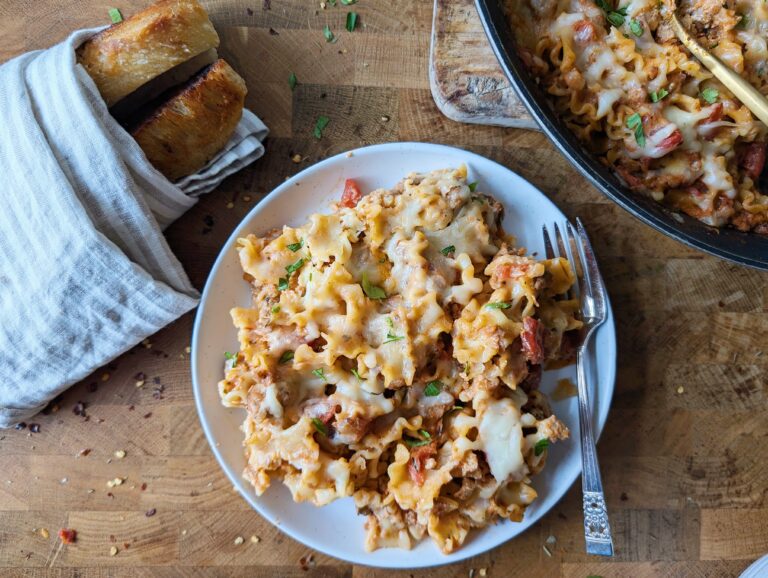 skillet lasagna in a bowl with bread on the side
