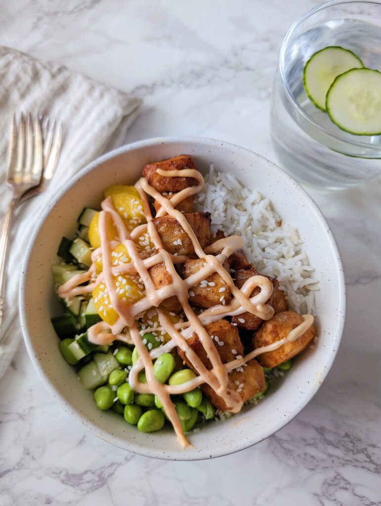over the view of the salmon bowl with sauce on top