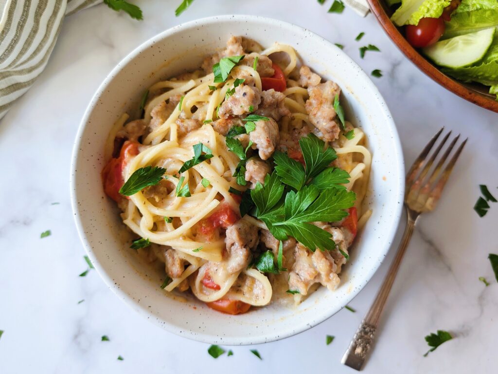 skillet pasta served in bowls with a salad