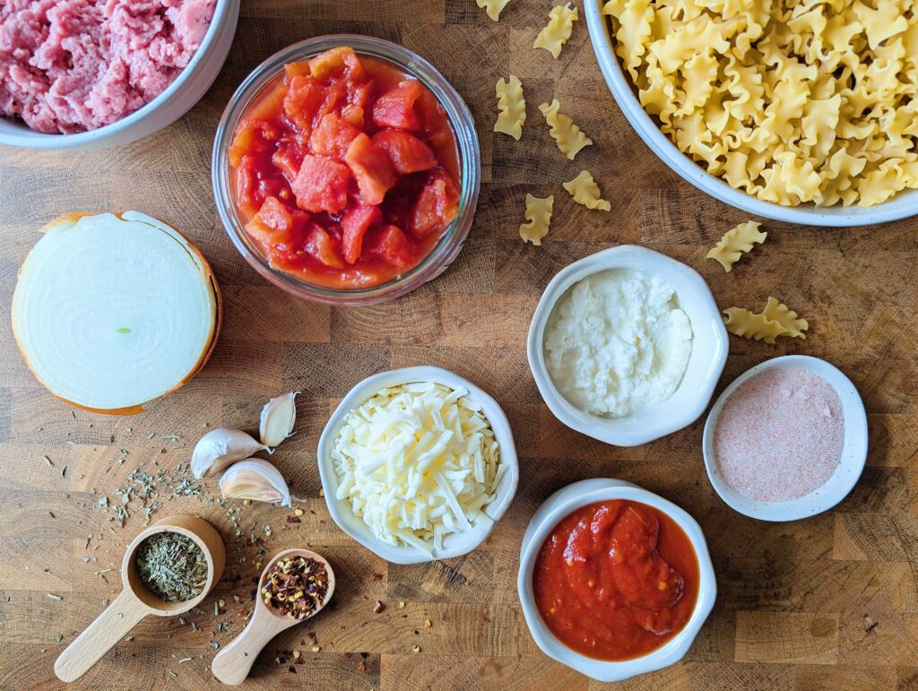 top down view of ingredients needed for skillet lasagna including malfada noodles, tomatoes and cheese