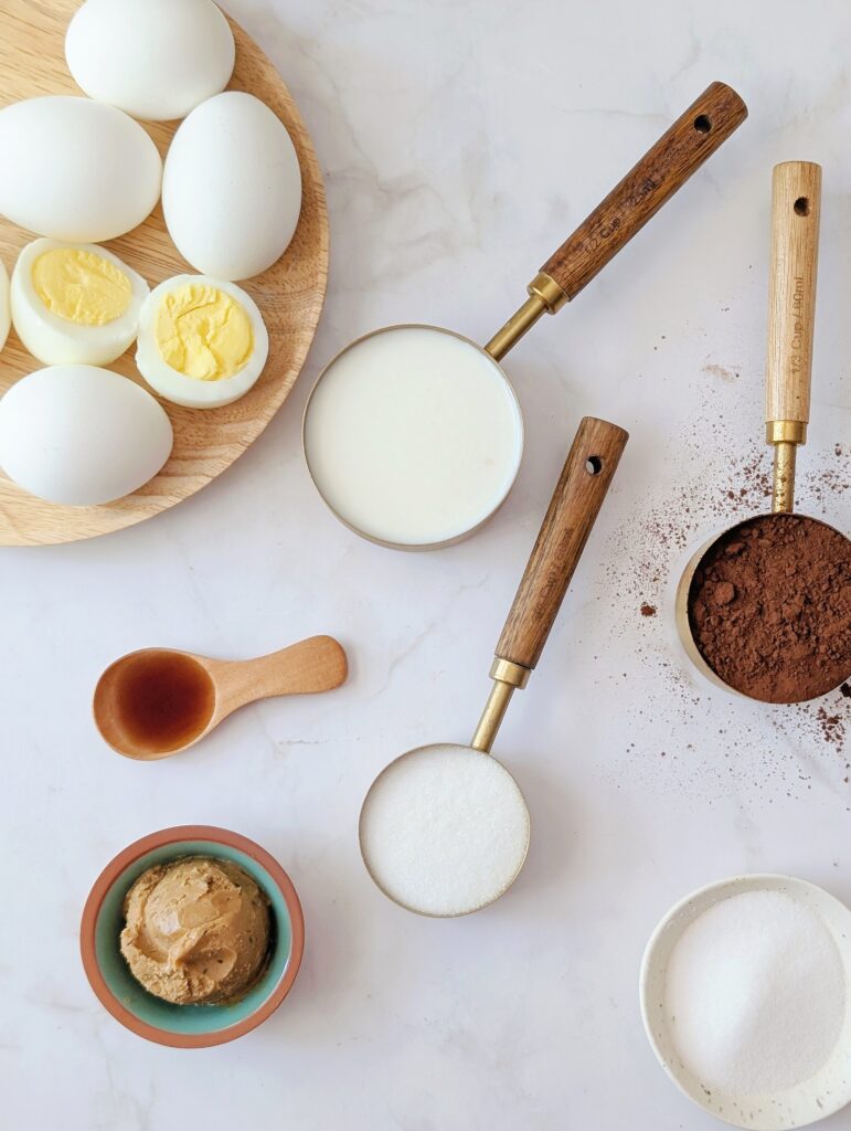 top down of ingredients needed to make lunchbox chocolate pudding made with hardboiled eggs