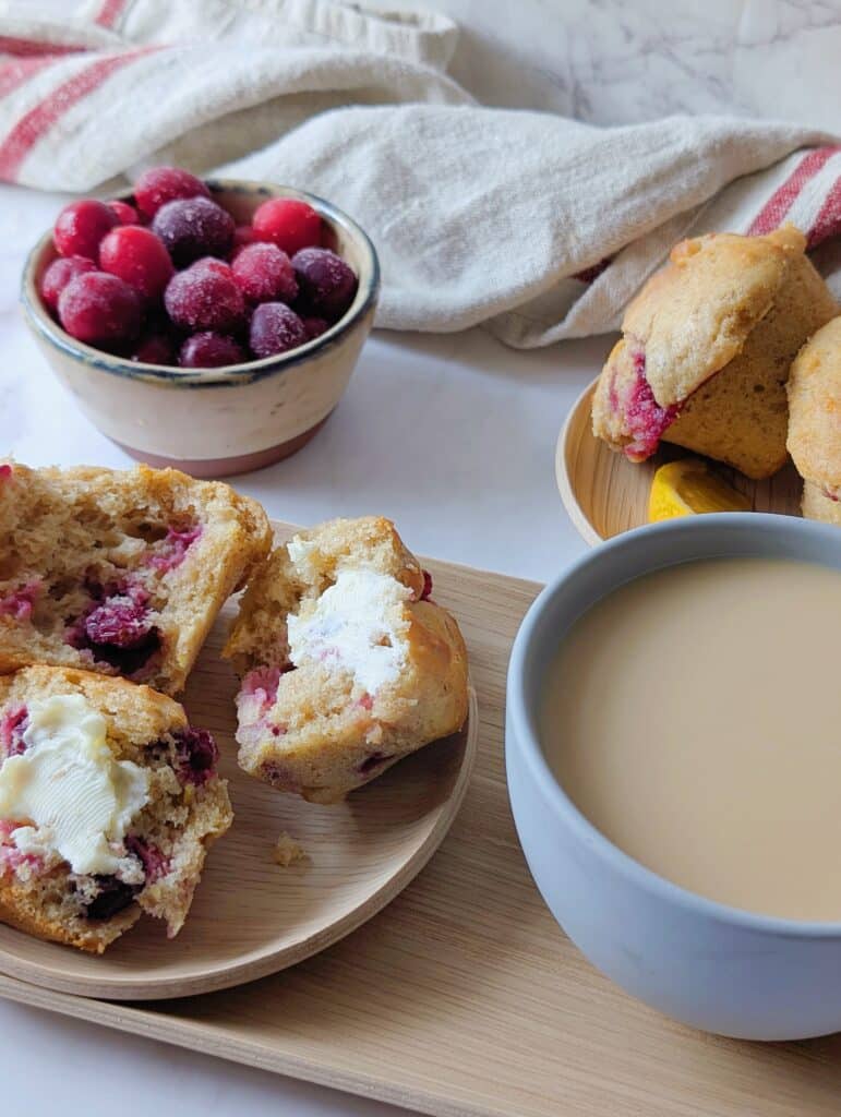 cranberry orange muffins with butter on a plate