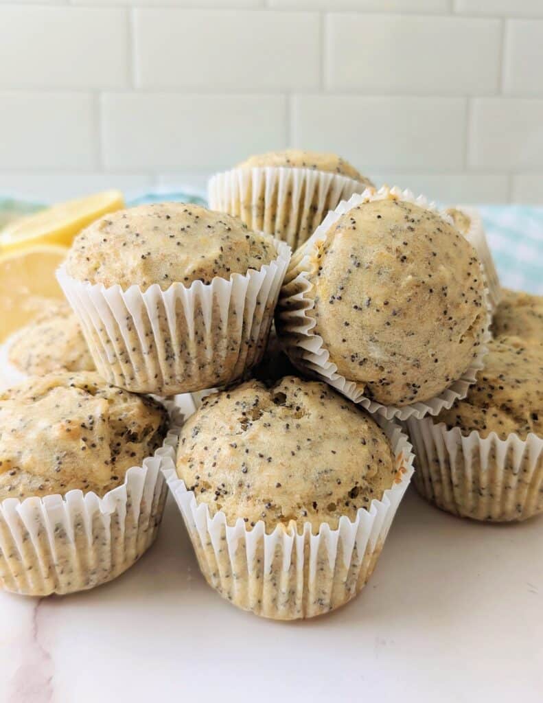 close up of lemon poppy seed muffins in a pile on a table