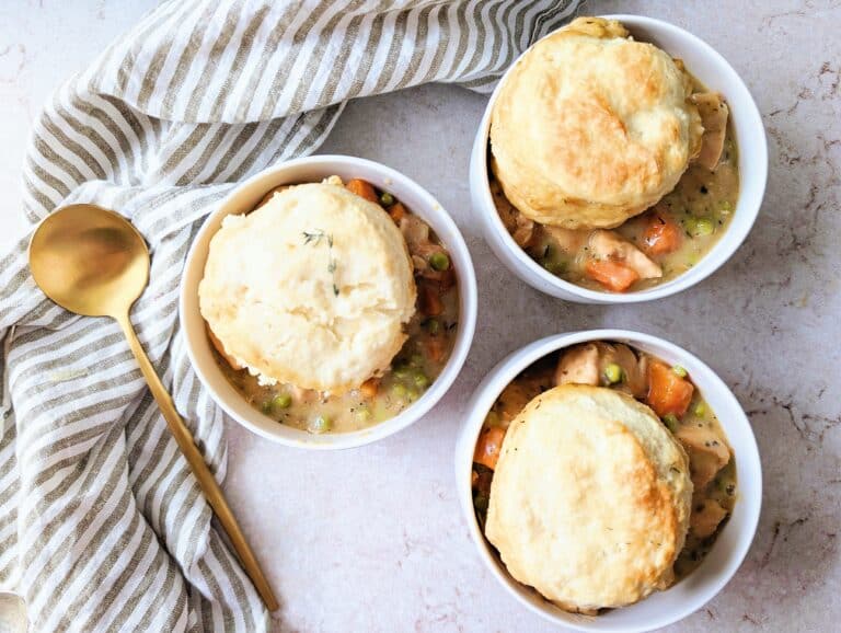 top down view of chicken stew with biscuits in little white ramekins