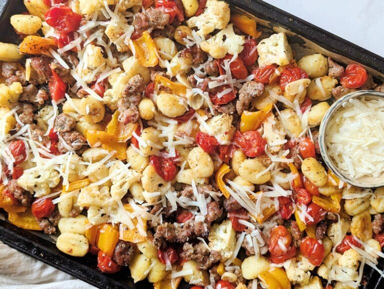 close up of sheet-pan gnocchi with sausage on a baking sheet