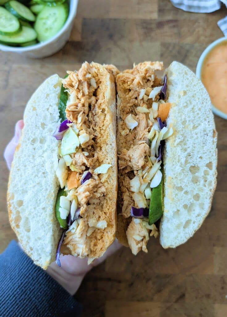 Sarah holds a top-down slow cooker gochujang chicken sandwich
