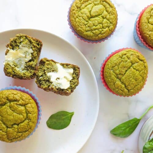banana spinach blender muffins on a plate with butter
