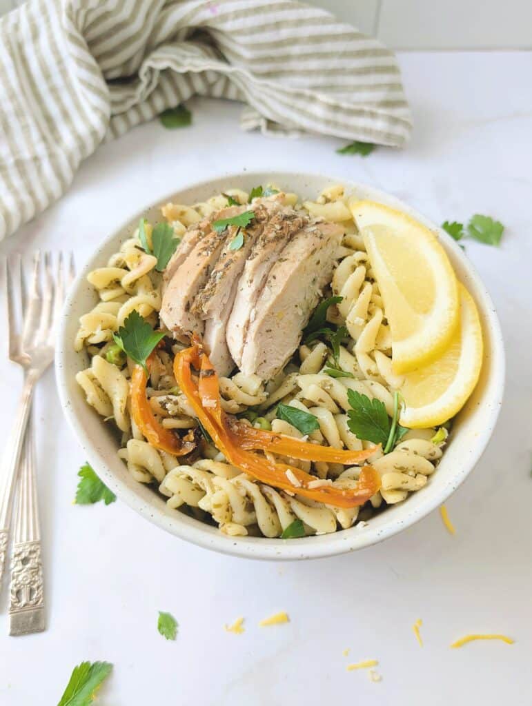 side view of chicken pesto pasta in a bowl