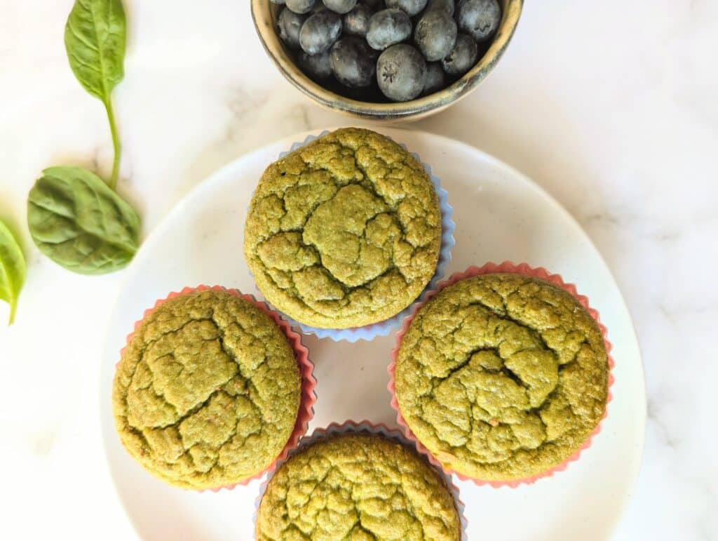 top down view of blender muffins with blueberries in a bowl