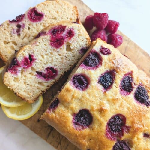 Top down view of raspberry lemon loaf cut into two slices on a cutting board