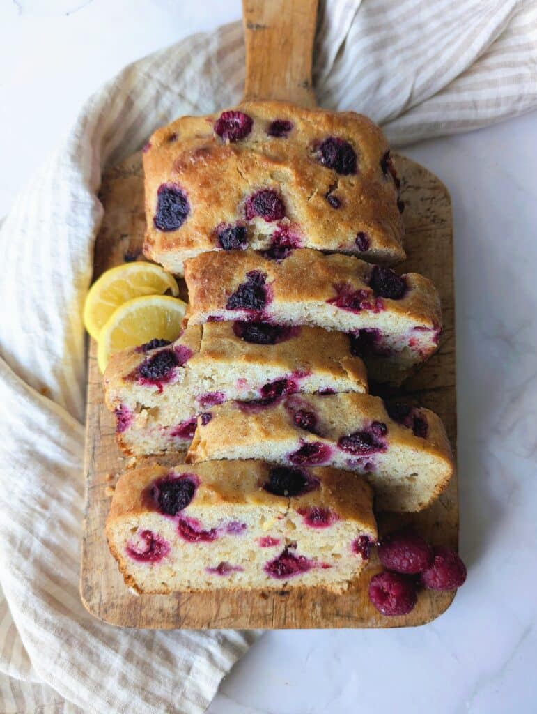 top down view of raspberry lemon loaf cut into slices on a cutting board