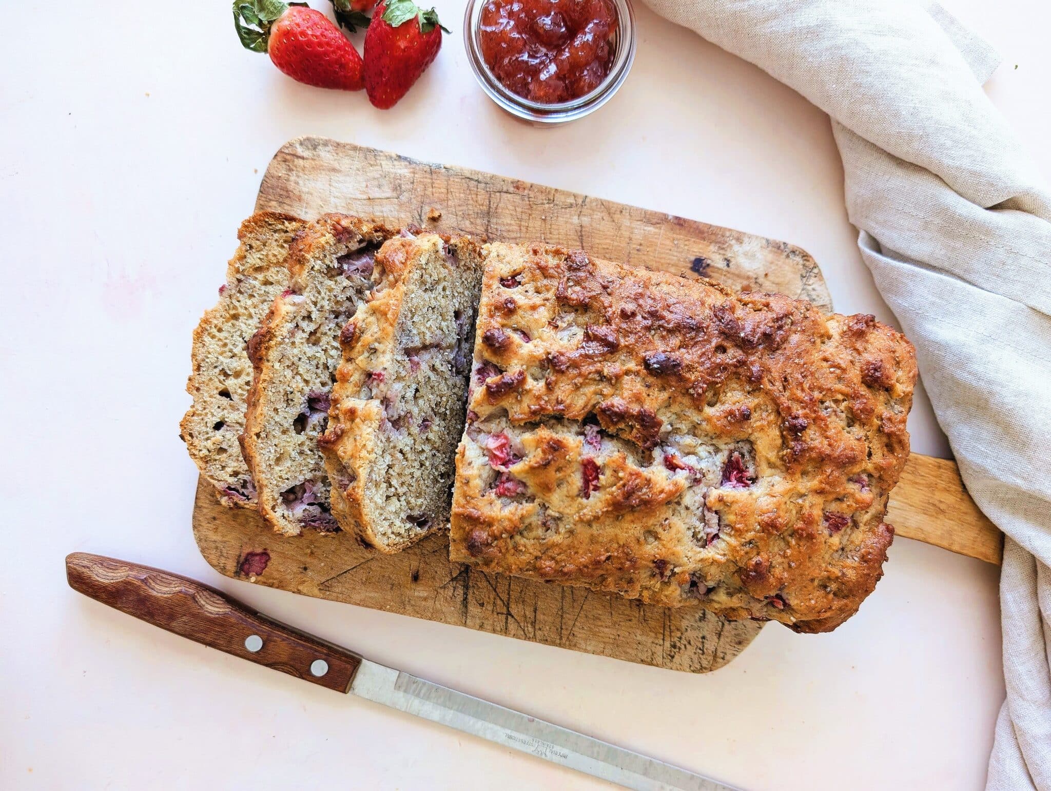 top down view of strawberry yogurt loaf for kids in slices resting on a cutting board