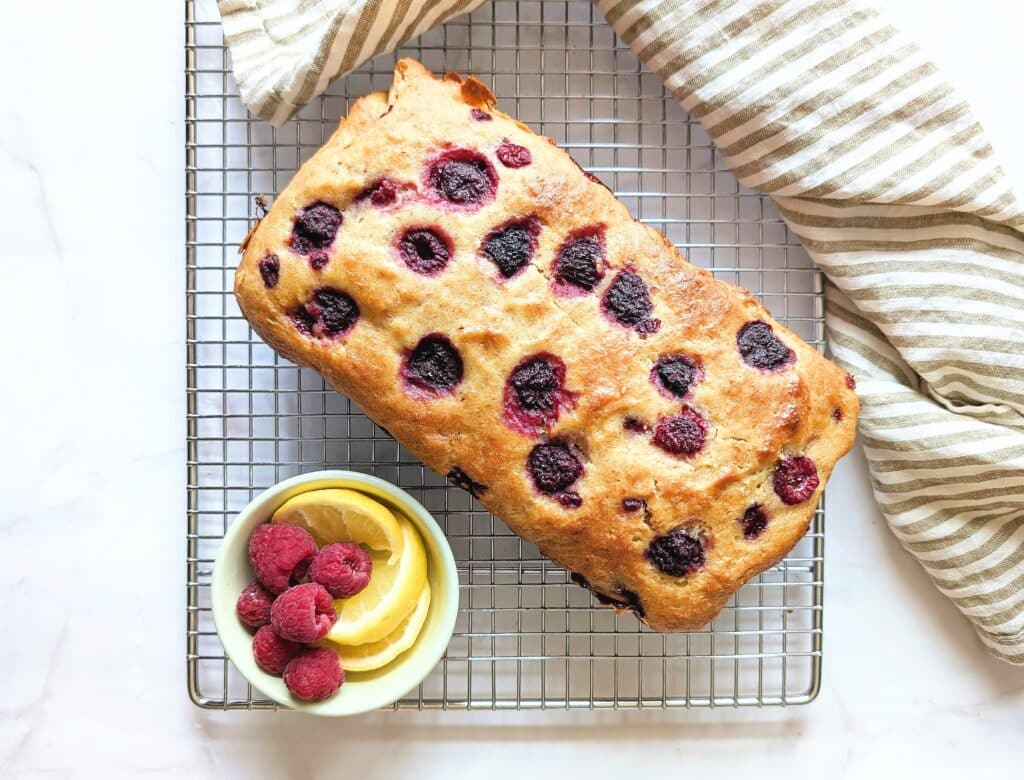 top down view of raspberry lemon loaf on a cooling rack