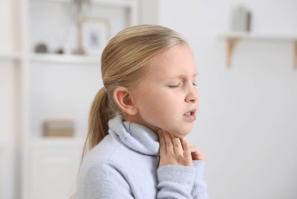 little girl with a sore throat after back to school
