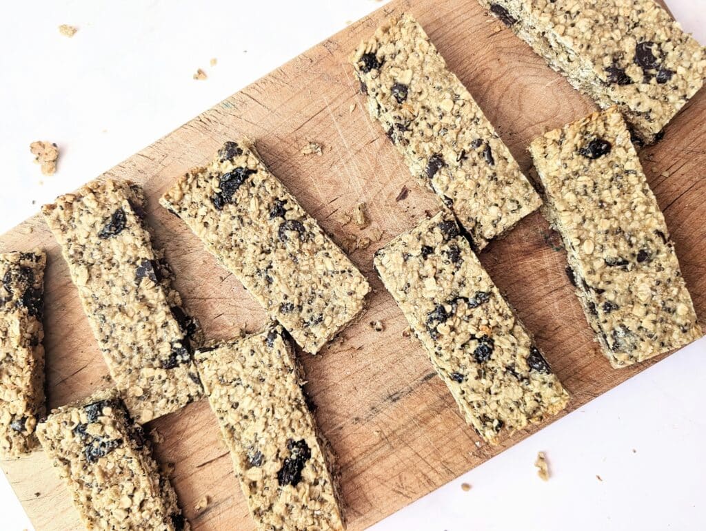 top down view of dark chocolate cherry granola bars on a wooden board