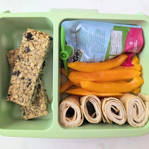 top down view of dark chocolate cherry granola bars in school lunch box