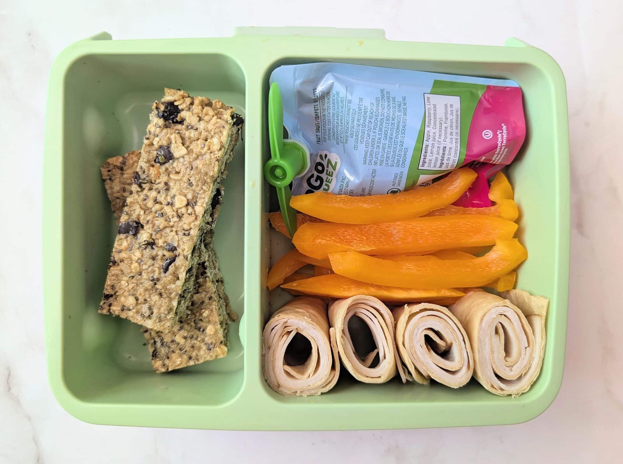 top down view of dark chocolate cherry granola bars in school lunch box