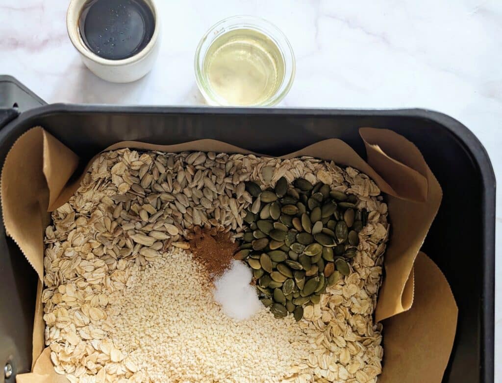 top down view of dry ingredients for air fryer granola added to basket