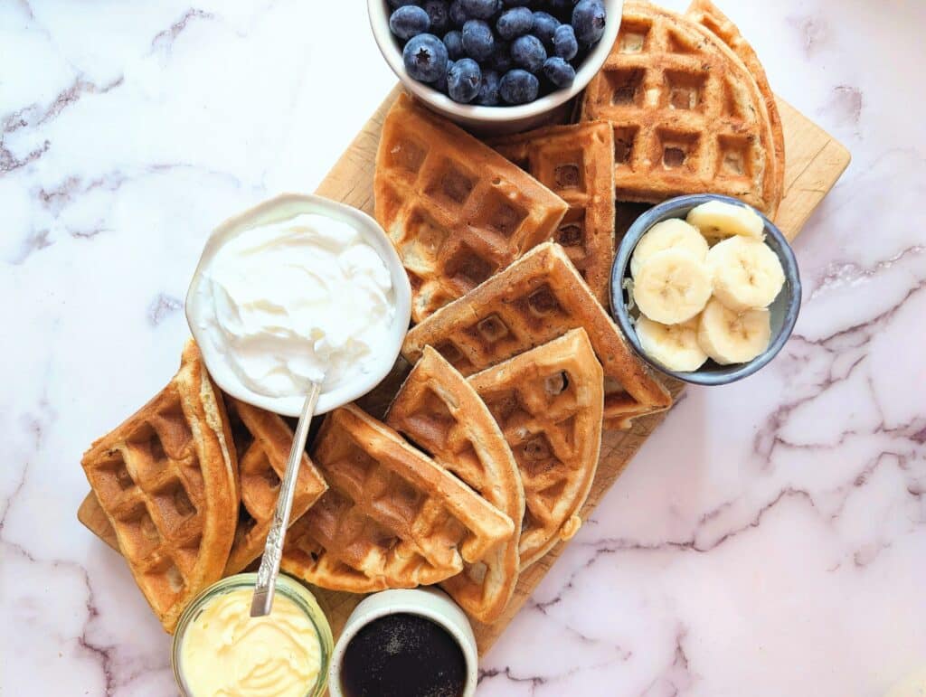 protein waffles for kids on a marble slab with berries