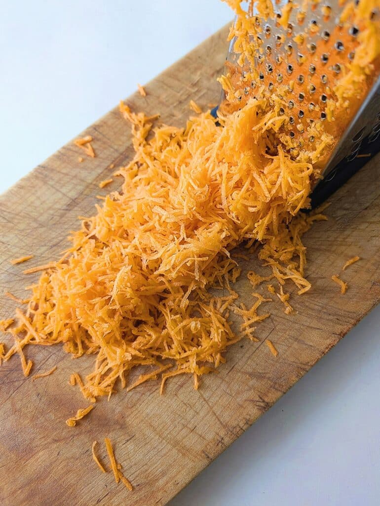 grated carrots on a wooden board