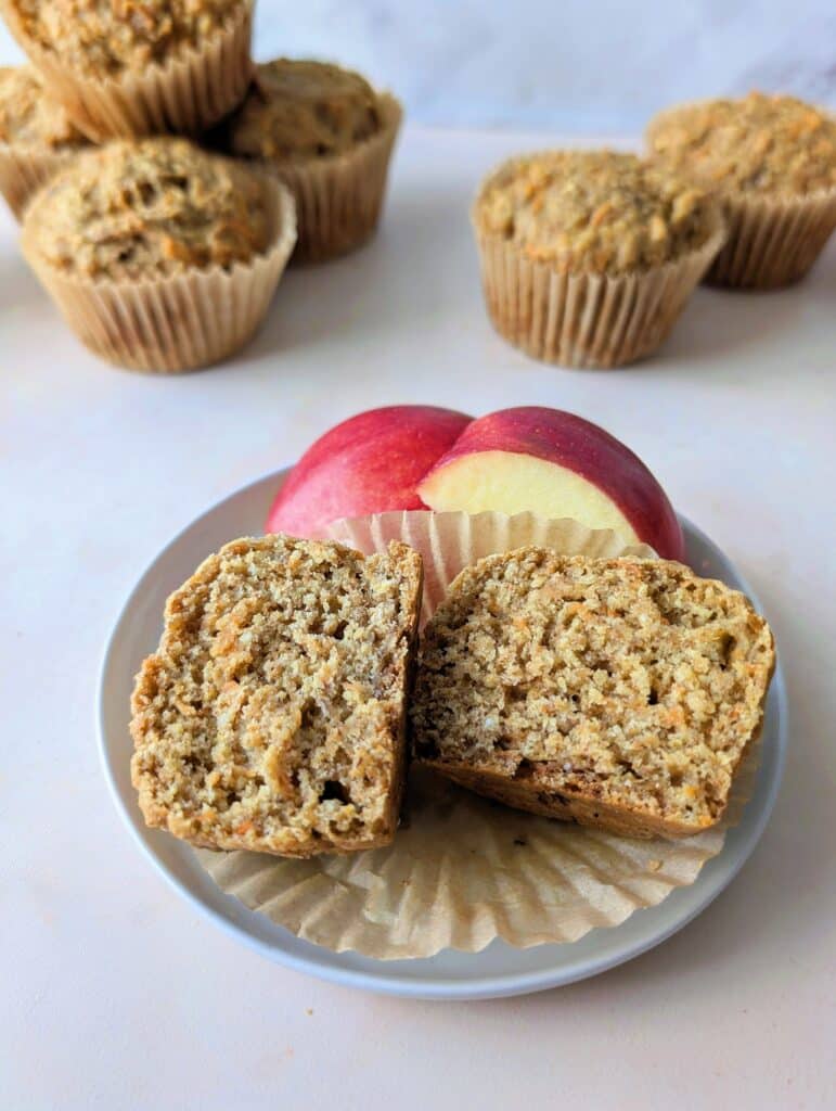 apple banana carrot muffin on a plate with apple slices