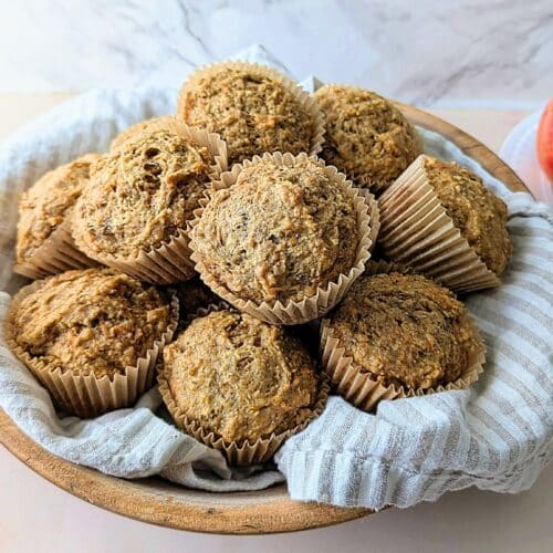 apple banana carrot muffins on a plate with apples in background