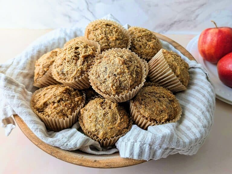 apple banana carrot muffins on a plate with apples in background