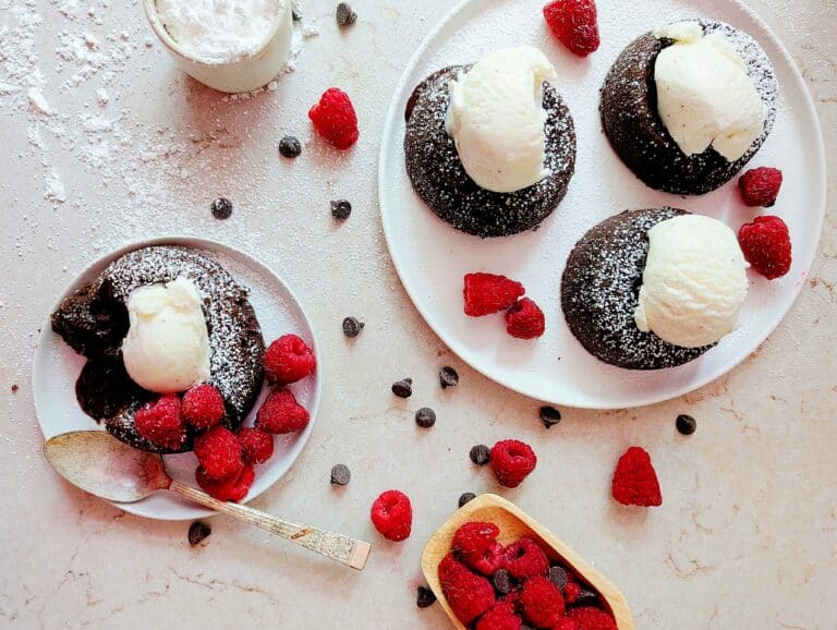 lava cakes with ice cream and raspberries on a plate top down view
