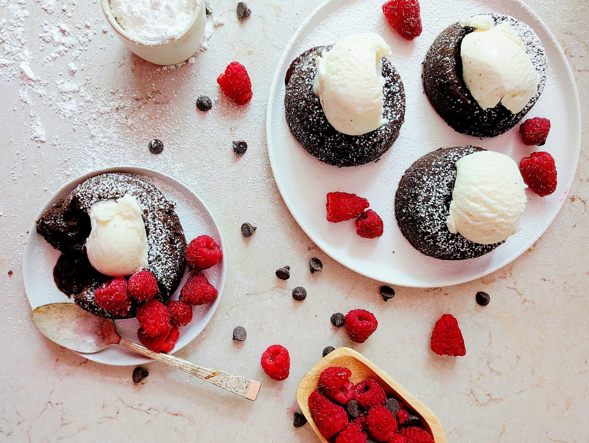 lava cakes with ice cream and raspberries on a plate top down view
