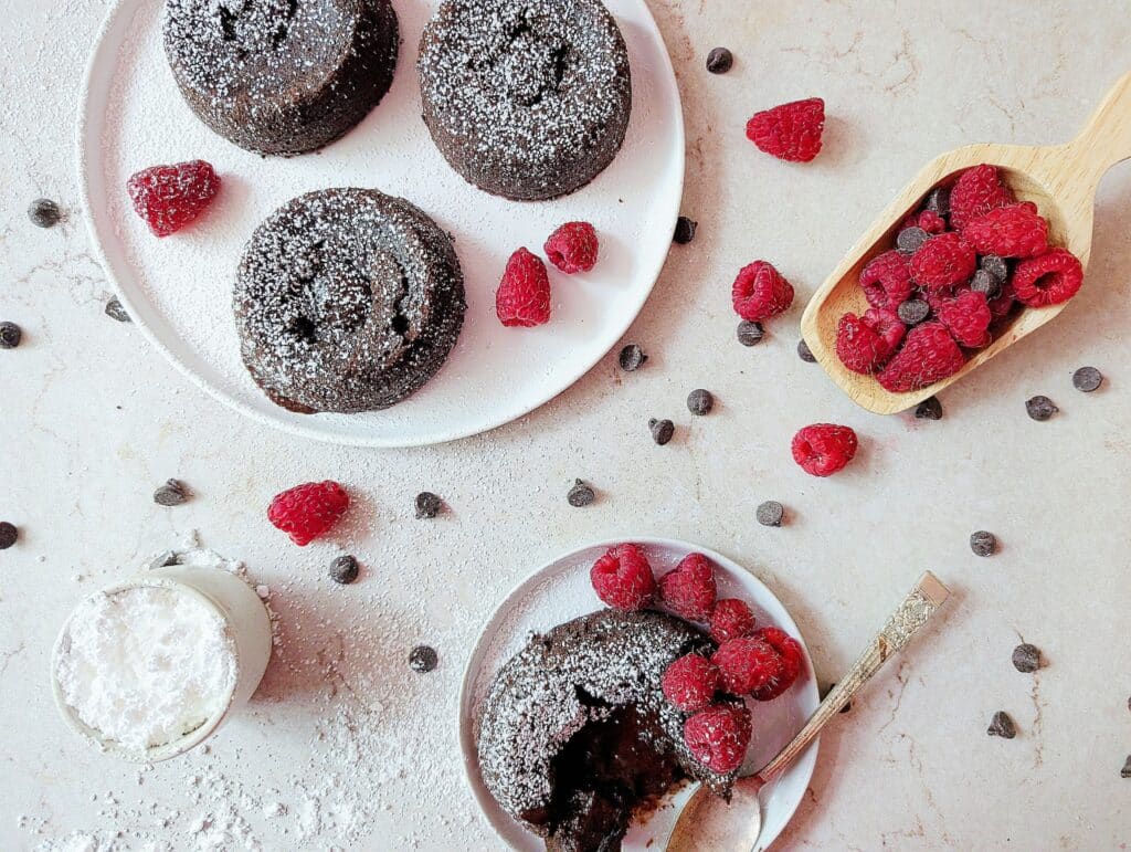 top down view of lava cakes on a plate with powdered sugar