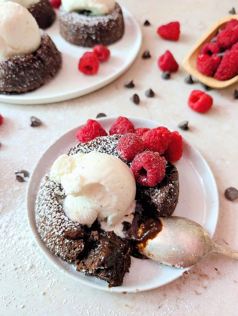 close up of lava cakes on a plate with ice cream and melting